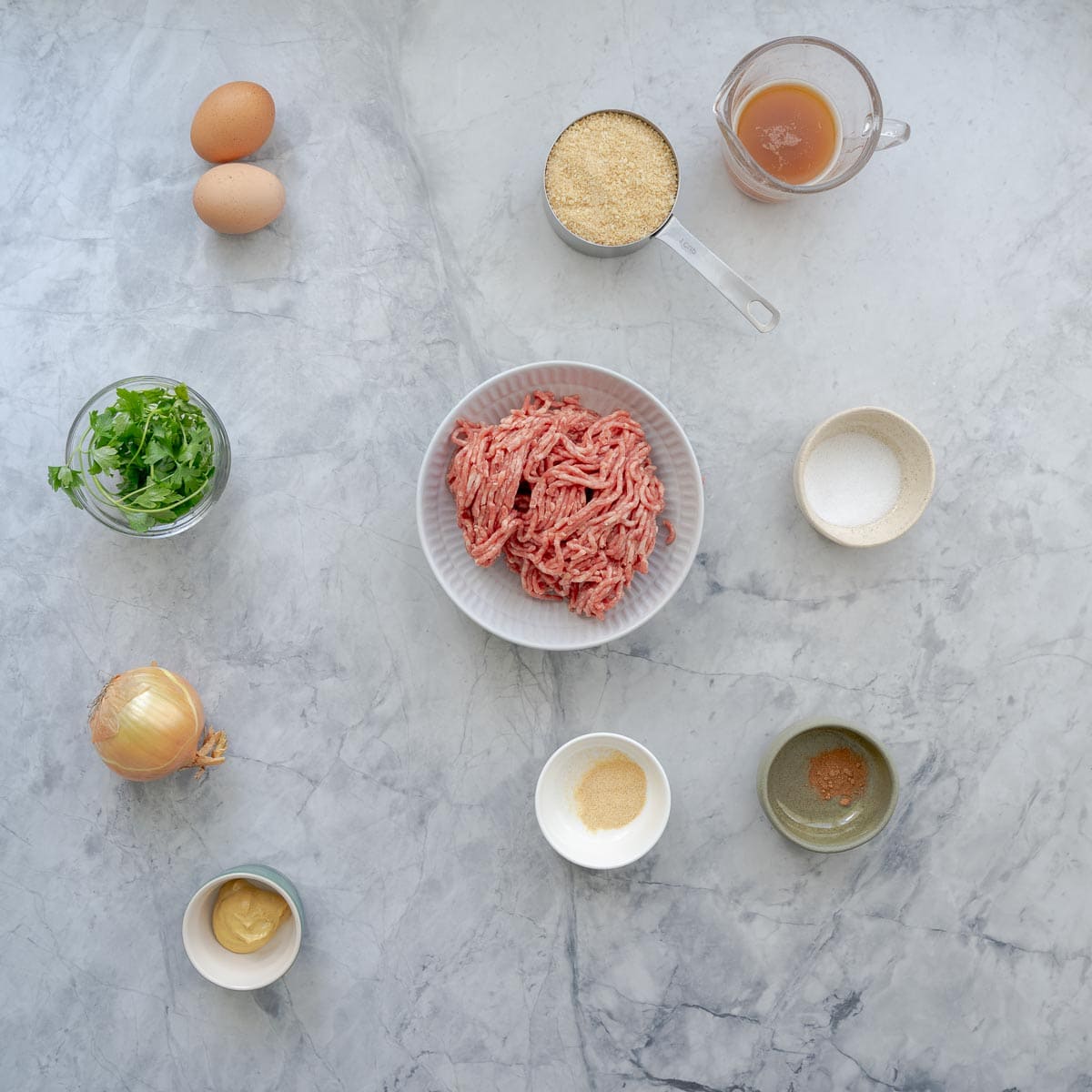 All the ingredients to make the baked meatballs laid out on the bench, 